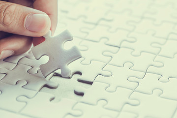 Fototapeta premium Pieces of jigsaw on palm,Pieces of jigsaw puzzle in man's hands