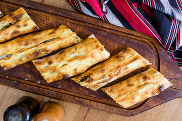 Traditional Turkish Pide at Kebab Restaurant on Wooden Table.