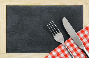Chalk board background with fork and knife