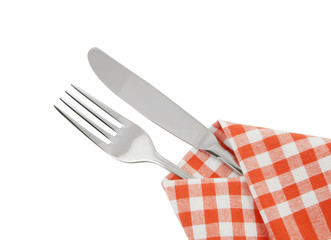 Knife and fork on red checked tablecloth isolated