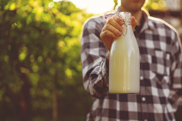 farmer holding a fresh natural milk in bottle