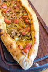Traditional Turkish Pide at Kebab Restaurant on Wooden Table.