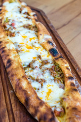 Traditional Turkish Pide at Kebab Restaurant on Wooden Table.