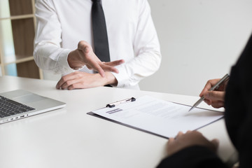 Executives are interviewing job applicants and preliminary background checks, candidates are talking about their past work experience, personal managers make hiring decisions.