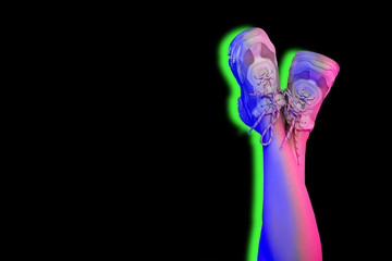Raised up female legs in white sneakers. Trend neon lights and shadow