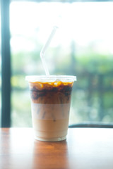 Iced caramel macchiato coffee with chocolate syrup