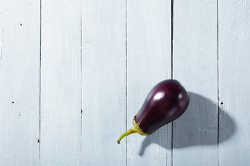 eggplant with shade on bright wood table