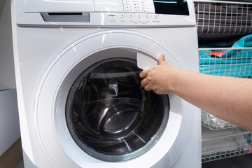Woman Hand is Opening a Door of Washing Machine, Housekeeping Lifestyle Concept, Electronic Household Equipment for Washing Clothes.