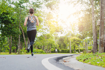 young fitness woman running at the park in morning.