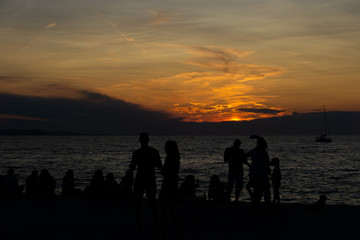 many people watch the sunset at the sea together