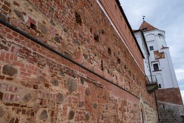 Photo of an ancient brick castle in nature in the summer.