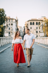 Obraz premium Stylish loving couple walking and laughing. Wedding shooting on the streets of Rome, Italy.