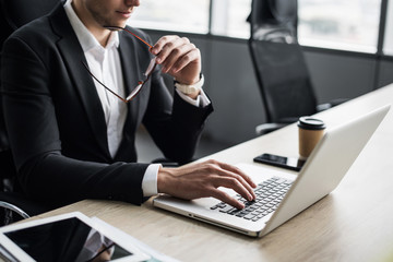 Businessman working on computer. Men using laptop in the office. Internet marketing, finance,...