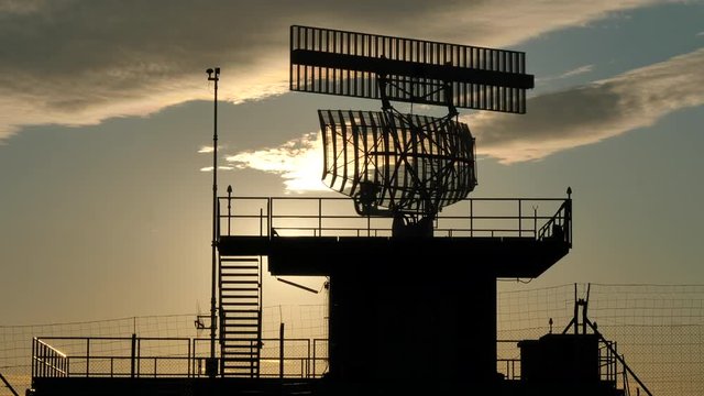 Silhouetted view of an all-around antenna for air defense and tracking made of phased array technology on a rotating platform