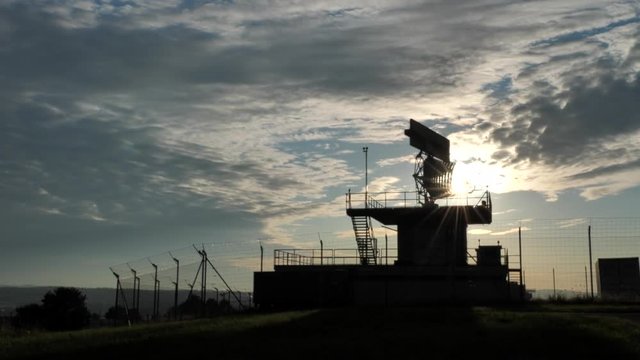 Silhouetted view of an all-around antenna for air defense and tracking made of phased array technology on a rotating platform