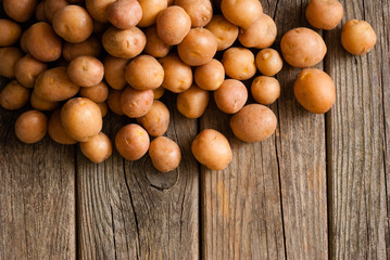 petite potatoes on rustic wood table background