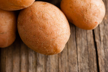 petite potatoes on rustic wood table background