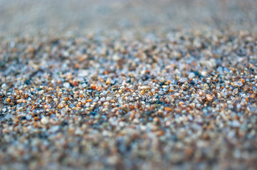 Close-up of Wet Coarse Sand. Travel Concept.