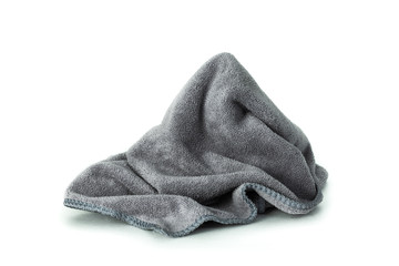 Microfiber cloth isolated on pure white background. Dirty rag made from soft fabric with cleaner equipment.