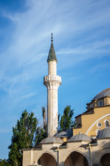Fototapeta na wymiar Old mosque on a background of blue sky and trees