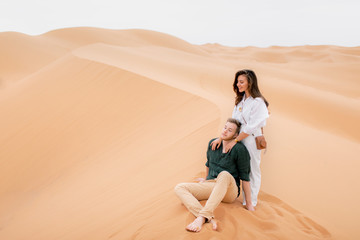Fototapeta na wymiar Loving couple in Sahara Desert.