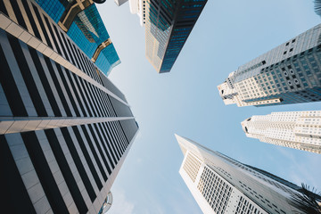 Modern glass city buildings during sunny day.