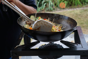 Cooking asian food in a wok pan