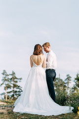 Happy couple outdoors at sunset. A stylish wedding in the European style of fine art.