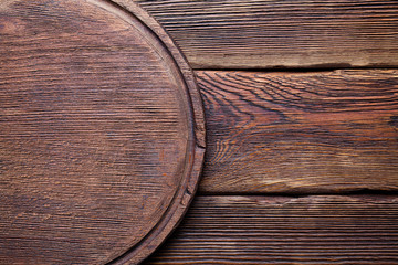 Wooden cutting board on old planks