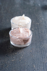 moisturizers on old black wood table