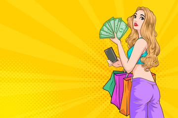 Woman holding money and shopping bags