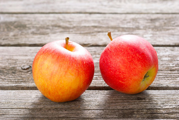 two apples on old wood table