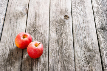 two apples on old wood table