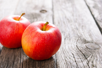 two apples on old wood table
