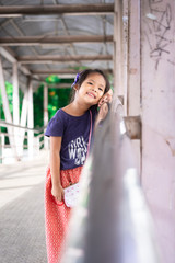 portrait of asian little girl on the bridge in the park