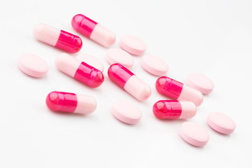 Obraz na płótnie Canvas Pharmacy theme. Pink capsules and antibiotic pills.