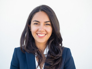 Happy successful businesswoman smiling at camera over white studio background. Closeup of beautiful...