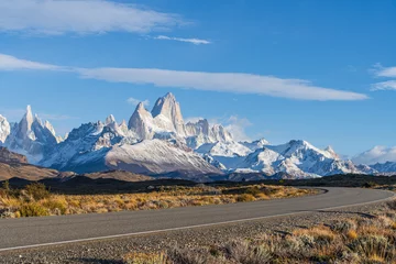 Photo sur Plexiglas Fitz Roy Beautiful Fitz Roy and Cerro Torre peak snow mountain in the morning blue sky with golden yellow grass beside the asphalt road route 40 road from El Calafate to El Chalten, south Patagonia, Argentina