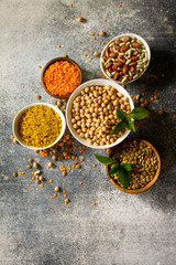 Healthy food, dieting, nutrition concept, vegan protein source. Raw of legumes (chickpeas, red lentils, canadian lentils, beans, bulgur, chickpea). Top view flat lay. Free space for your text.