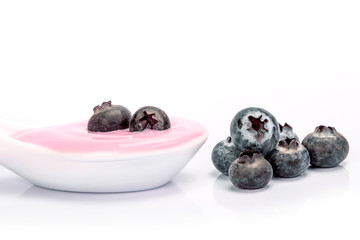 close up pink creamy homemade blueberries fruit yogurt  on white background