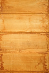 Orange paint coated wooden pine boards lying in a row as a close-up background composition