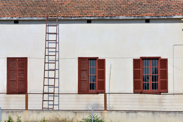 The stairs pass on the house window, in the village of Cyprus.