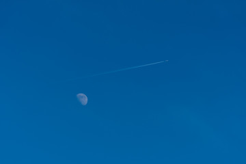 trace of the plane on the background of the moon.