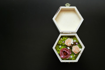 gold wedding rings in a decorated box