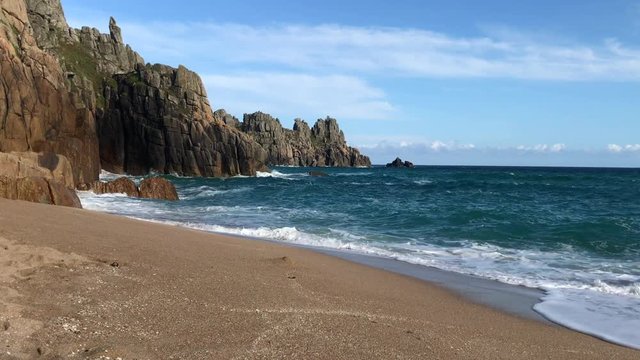 Cornish Sandy Beach with Ocean Waves Turquoise Seas and Rocky Cliffs