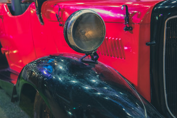 headlight of red vintage old classic car