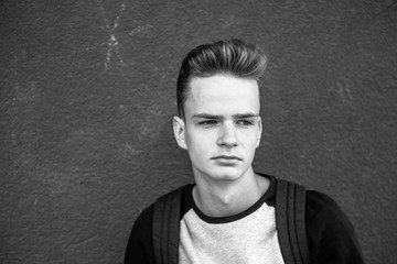 Fototapeta premium Serious handsome teenage blond boy with stylish haircut 