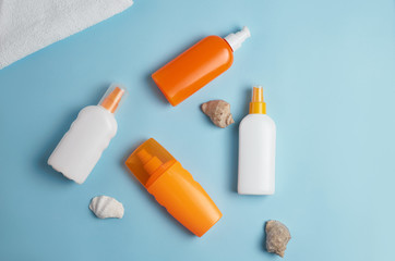 Sun cream, cream, sunscreen bottle, sun cream, lotion bottle, seashells. Beach flat lay accessories. Summer travel holiday concept. Summertime vacation