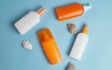 seashells and sunscreen on a colored background top view. Sunscreen