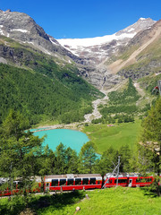 Naklejka na ściany i meble Swiss mountain train Bernina Express crossed Alps with glaciers in the summer
